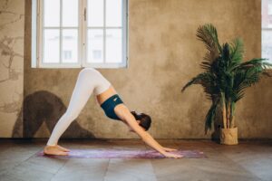 woman doing yoga pose downward facing dog