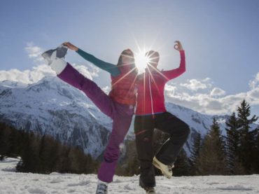 two guests yoga pose with sun behind them yoga and skiing holiday french alps