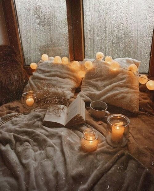 rejuvenate pillows by window with candles