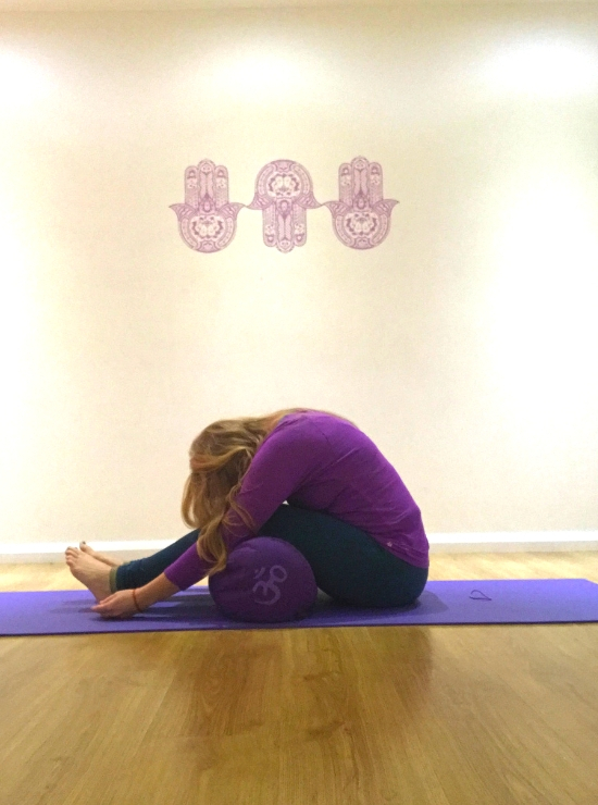 forward fold over bolster yin yoga pose ease back pain