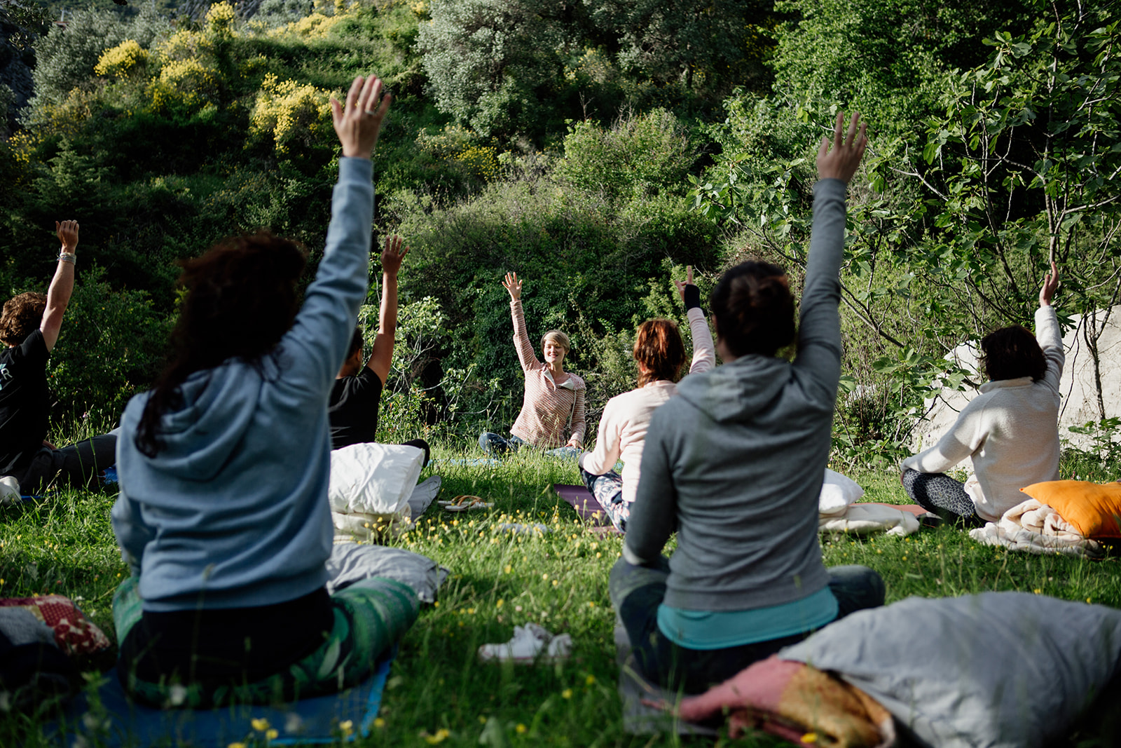 seated yoga outside on grass - hiking yoga holiday montenegro