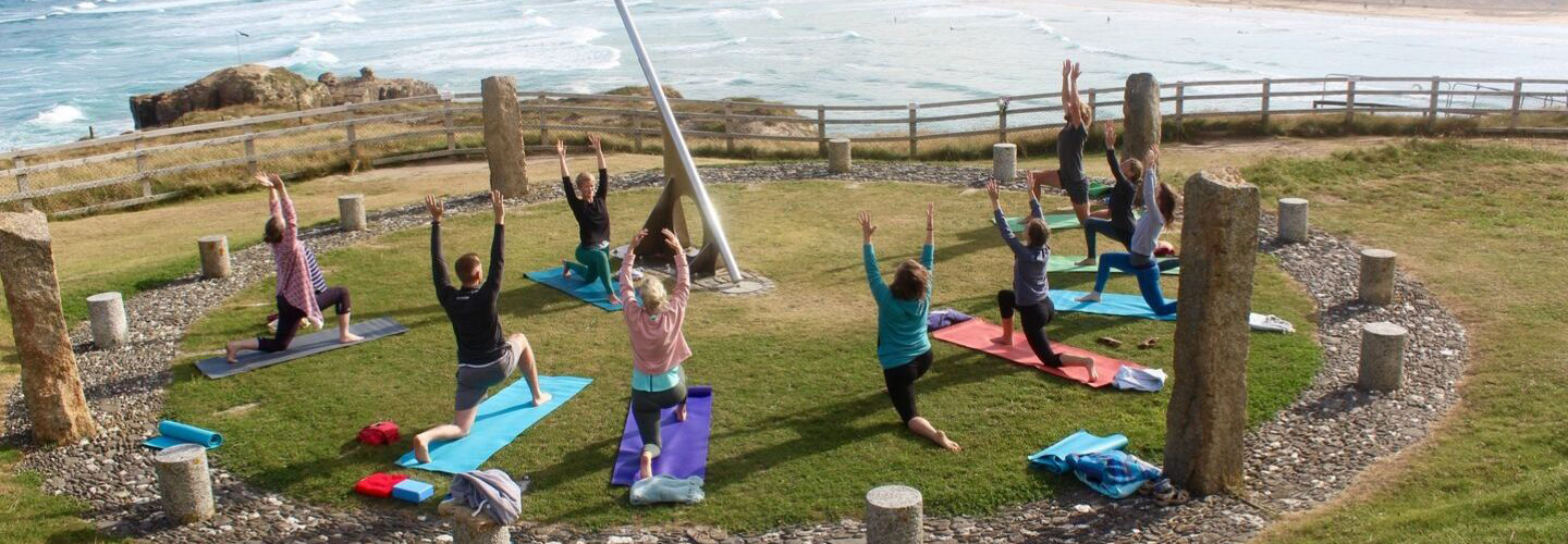 people doing yoga outside Cornwall yoga retreat UK
