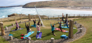 yoga class on cliffs by sea cornwall