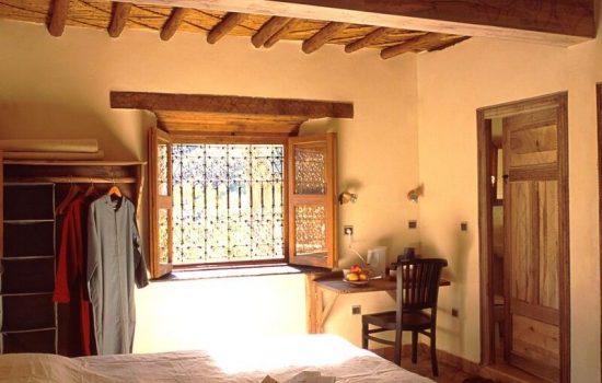 standard room double bed-window-door-wardrobe