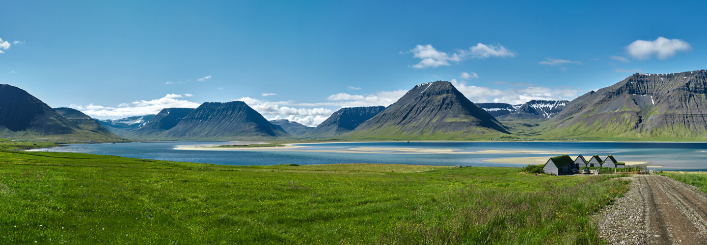 Iceland summer landscape mountains, lake, houses