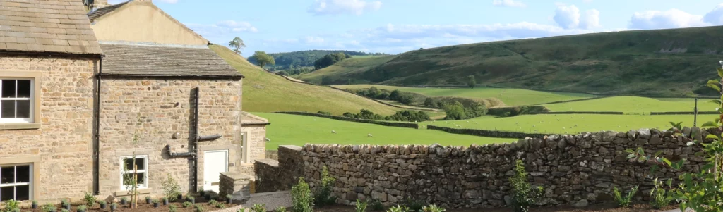 view of valley and farmhouse