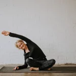 yoga teacher becky doing pose on yoga mat