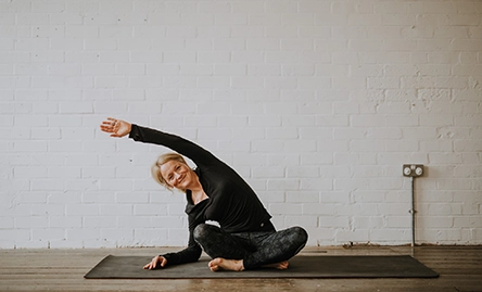 yoga teacher becky doing pose on yoga mat