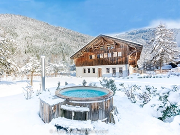 snowy farmhouse in samoens in the french alps with outdoor hot tub